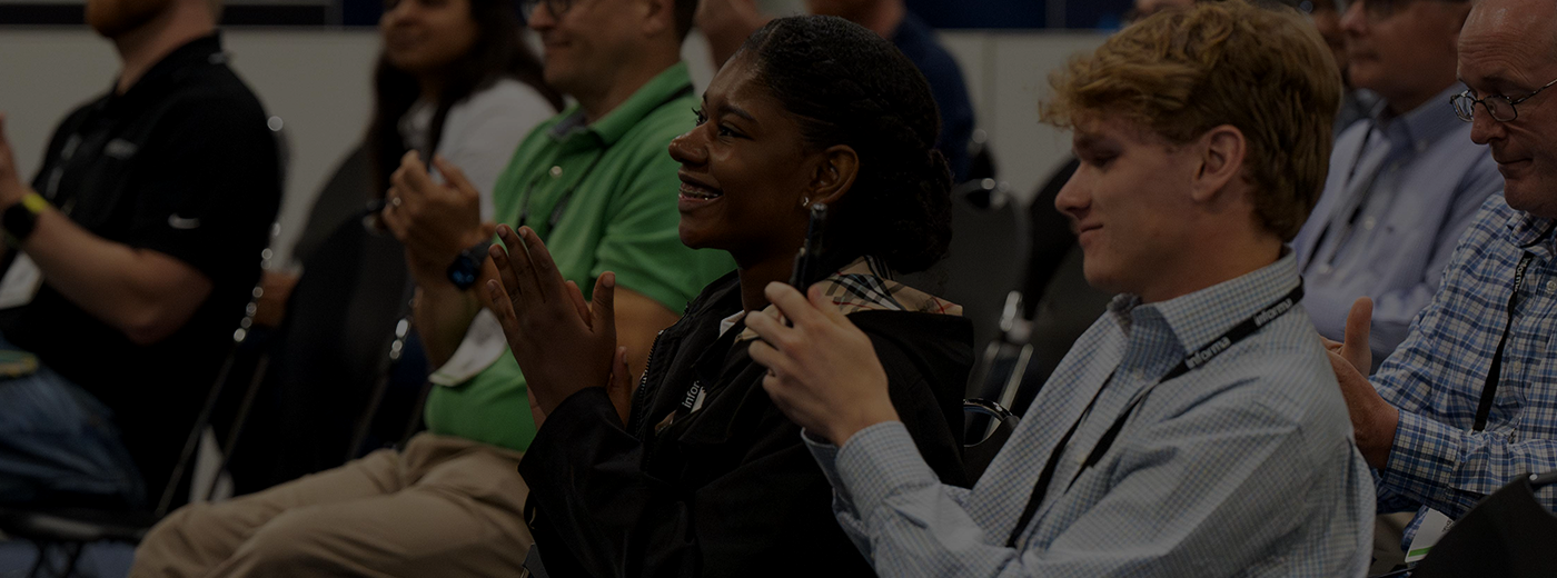A diverse group of people participate in a conference event