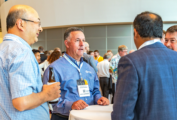Group of 4 men having a conversation on a network event 